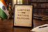 A5 wooden laser engraved plaque reading “Lawyers Are Natural Politicians” in bold typography with decorative border, framed in black with desk stand support, ideal for advocate chambers, law offices, and legal workspace décor.